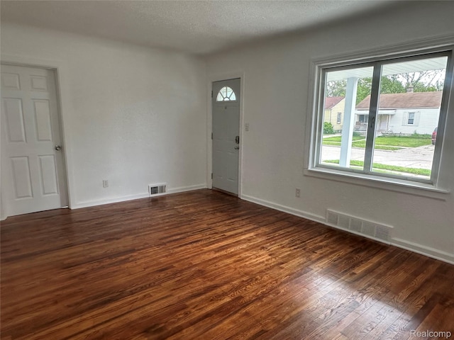 23767 Battelle Ave, Royal Oak, MI 48030 - unfurnished room with dark wood-type flooring, baseboards, and a textured ceiling