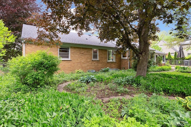 1220 Minglewood Way, Ann Arbor, MI 48103 - view of side of home featuring brick siding and a shingled roof