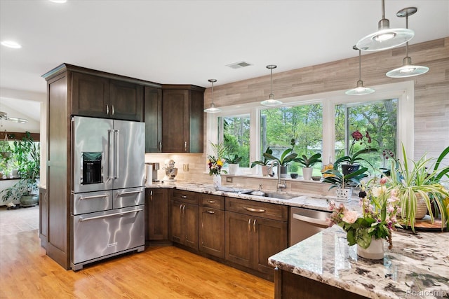 1220 Minglewood Way, Ann Arbor, MI 48103 - kitchen featuring stainless steel appliances, a sink, light stone counters, and healthy amount of natural light