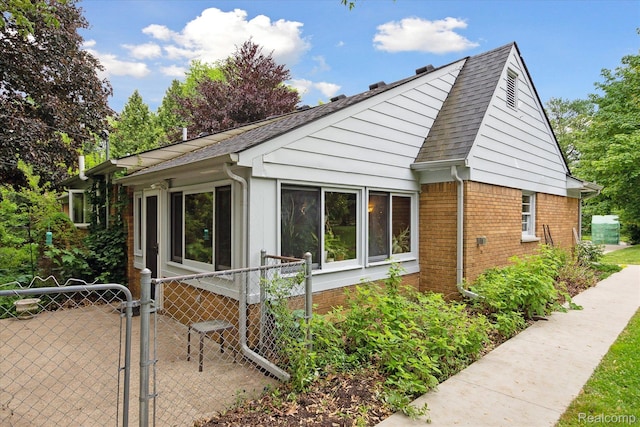 1220 Minglewood Way, Ann Arbor, MI 48103 - view of side of home with a gate, brick siding, and a shingled roof