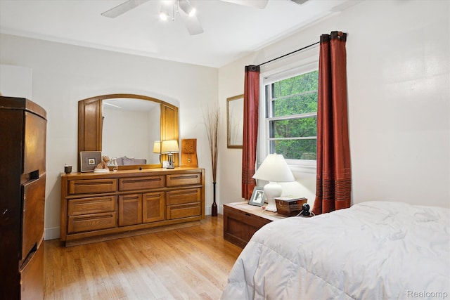 1220 Minglewood Way, Ann Arbor, MI 48103 - bedroom with light wood-style flooring, arched walkways, and ceiling fan
