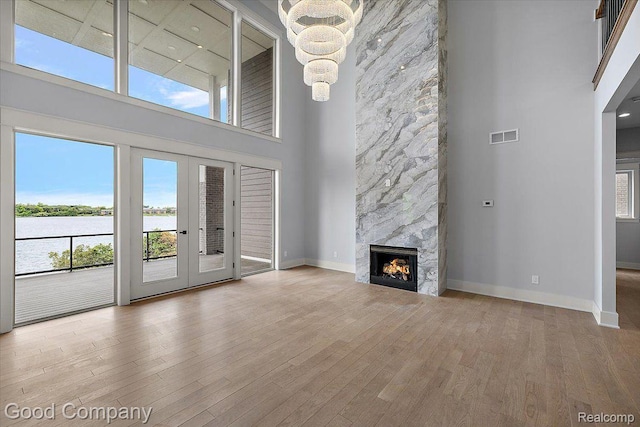 1760 Hamilton Dr, Bloomfield Hills, MI 48302 - unfurnished living room with a high ceiling, wood finished floors, a chandelier, baseboards, and french doors