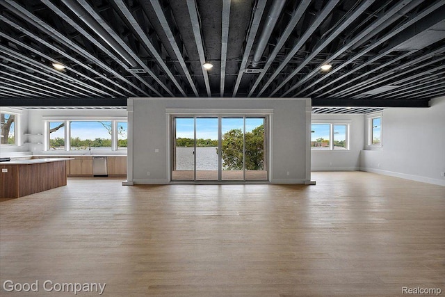 1760 Hamilton Dr, Bloomfield Hills, MI 48302 - unfurnished living room featuring healthy amount of natural light, light wood-style flooring, and baseboards
