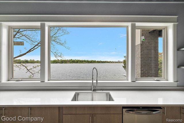 1760 Hamilton Dr, Bloomfield Hills, MI 48302 - kitchen featuring stainless steel dishwasher, a sink, light countertops, and a water view