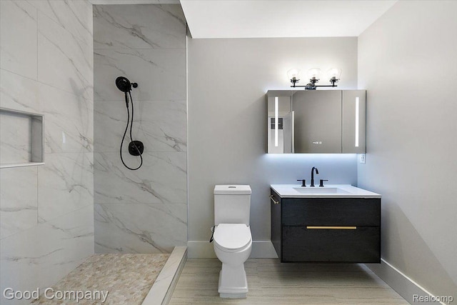 1760 Hamilton Dr, Bloomfield Hills, MI 48302 - full bathroom with a marble finish shower, vanity, toilet, and baseboards