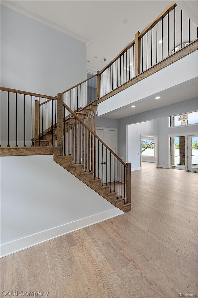 1760 Hamilton Dr, Bloomfield Hills, MI 48302 - staircase featuring wood finished floors, baseboards, recessed lighting, and a towering ceiling