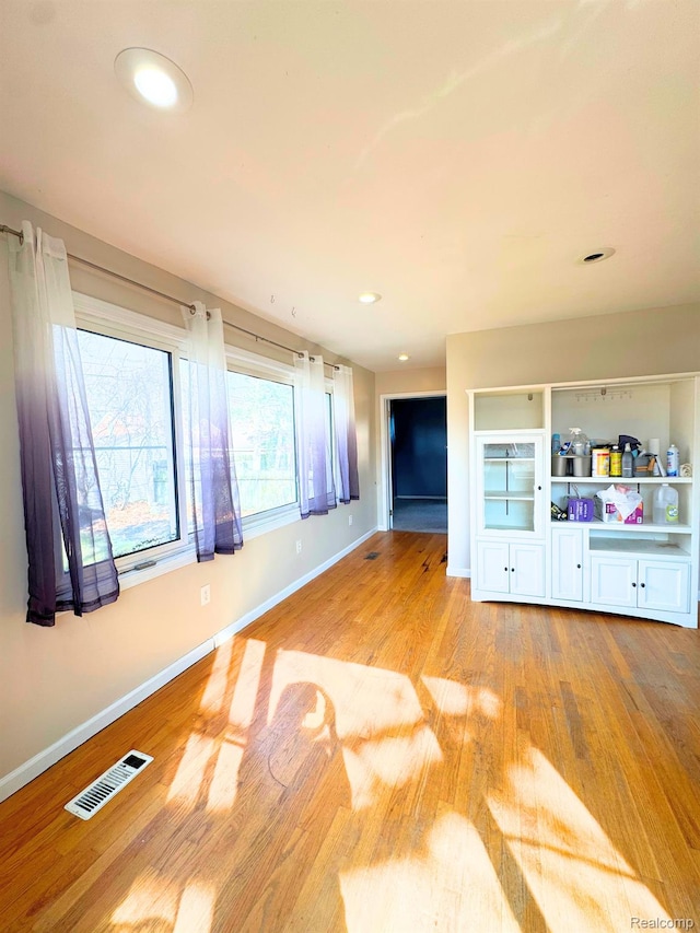 14070 Nadine St, Oak Park, MI 48237 - unfurnished living room with light wood-type flooring, baseboards, and recessed lighting