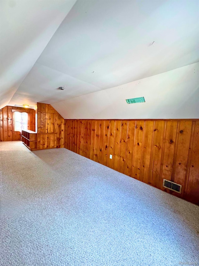 14070 Nadine St, Oak Park, MI 48237 - additional living space with wooden walls, vaulted ceiling, and carpet flooring