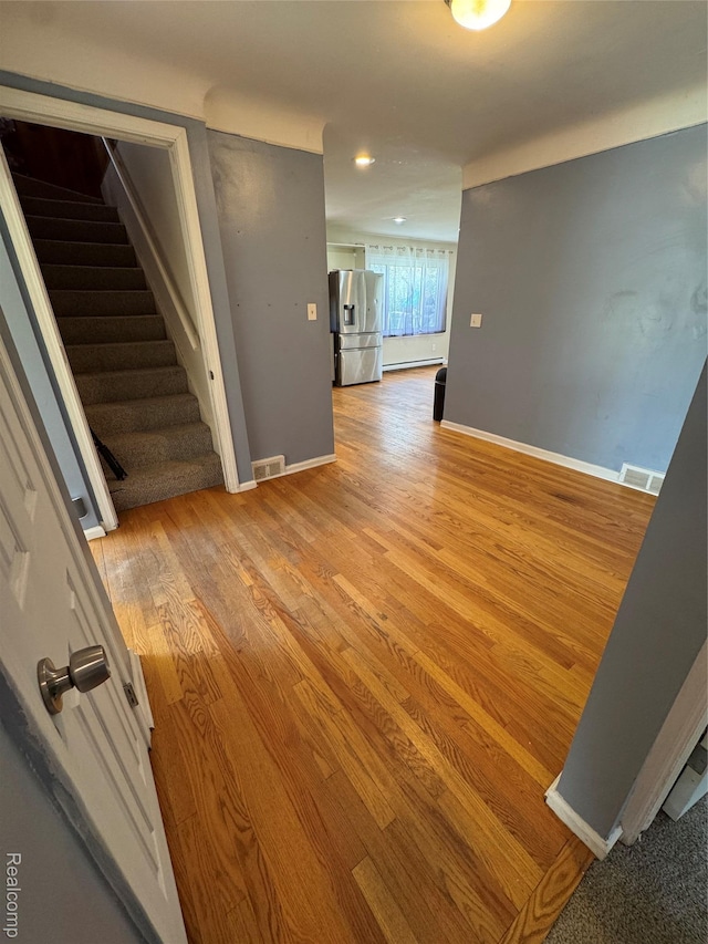 14070 Nadine St, Oak Park, MI 48237 - unfurnished room featuring stairs, wood finished floors, baseboards, recessed lighting, and a baseboard heating unit