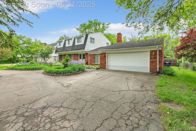 2408 Otter St, Warren, MI 48092 - dutch colonial featuring brick siding, a chimney, an attached garage, asphalt driveway, and roof with shingles