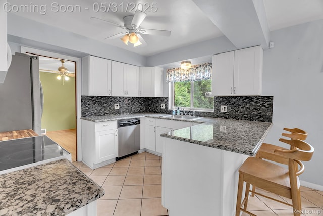 2408 Otter St, Warren, MI 48092 - kitchen featuring stainless steel appliances, a ceiling fan, a peninsula, and white cabinetry