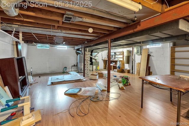 2408 Otter St, Warren, MI 48092 - below grade area featuring stairway, wood finished floors, water heater, and a central vacuum unit