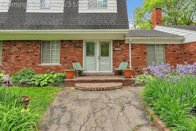 2408 Otter St, Warren, MI 48092 - doorway to property featuring roof with shingles and brick siding