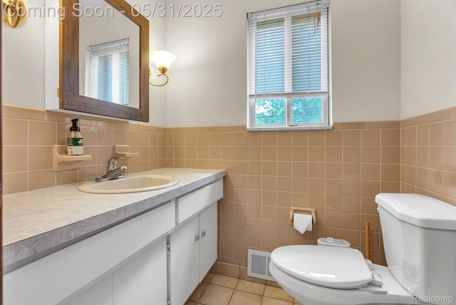 2408 Otter St, Warren, MI 48092 - half bathroom with tile walls, toilet, vanity, tile patterned floors, and a wainscoted wall