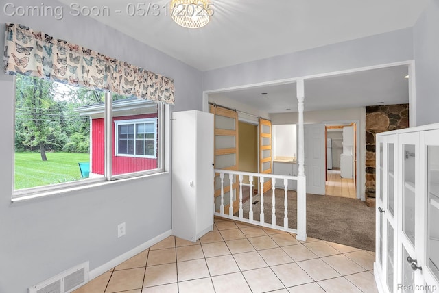 2408 Otter St, Warren, MI 48092 - unfurnished room with light tile patterned floors and a barn door