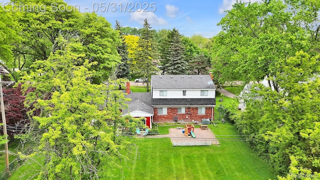 2408 Otter St, Warren, MI 48092 - rear view of house with a patio, brick siding, a yard, and central AC
