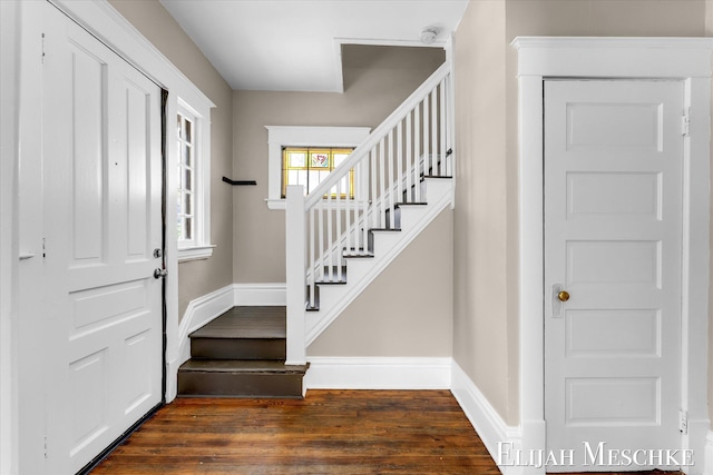 621 Olympia St SW, Grand Rapids, MI 49503 - foyer entrance featuring dark wood finished floors, stairway, and baseboards