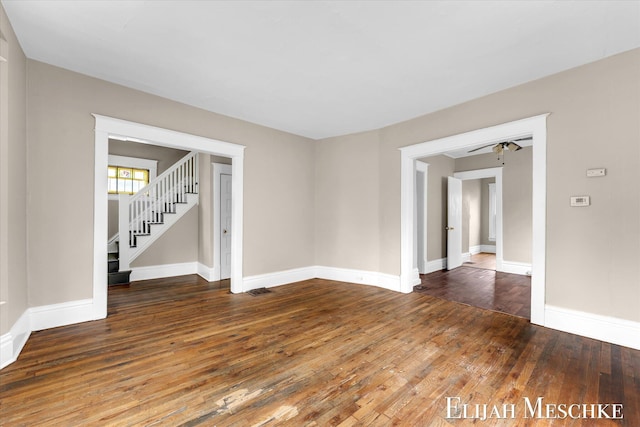 621 Olympia St SW, Grand Rapids, MI 49503 - empty room featuring hardwood / wood-style floors, baseboards, stairway, and ceiling fan