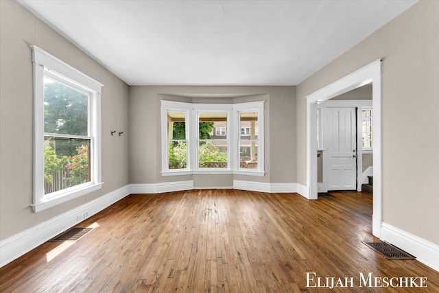 621 Olympia St SW, Grand Rapids, MI 49503 - empty room featuring plenty of natural light, hardwood / wood-style flooring, and baseboards