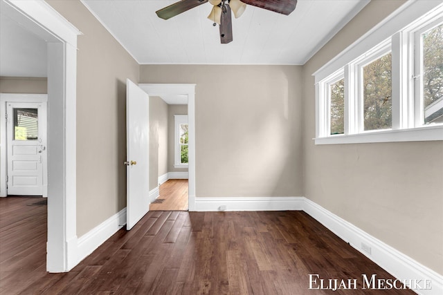 621 Olympia St SW, Grand Rapids, MI 49503 - spare room with healthy amount of natural light, a ceiling fan, dark wood-type flooring, and baseboards