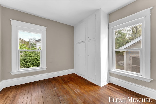 621 Olympia St SW, Grand Rapids, MI 49503 - unfurnished bedroom with baseboards and hardwood / wood-style floors