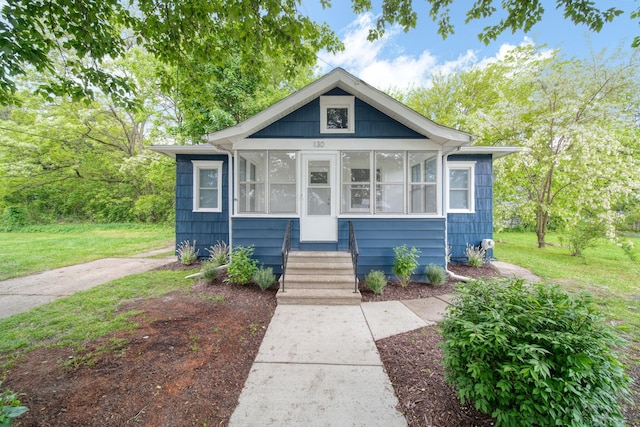 130 N Horton St, Jackson, MI 49202 - view of front of home with a sunroom and a front yard