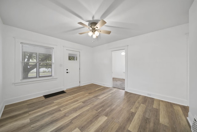 130 N Horton St, Jackson, MI 49202 - empty room featuring a ceiling fan, wood finished floors, and baseboards