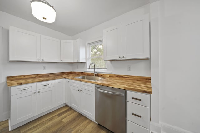 130 N Horton St, Jackson, MI 49202 - kitchen with butcher block counters, stainless steel dishwasher, a sink, white cabinets, and light wood-style flooring