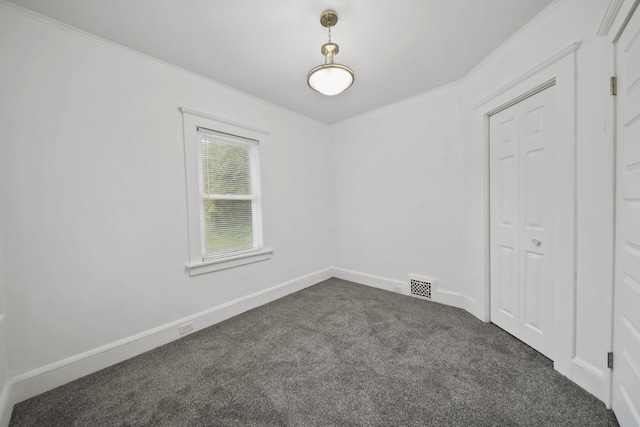 130 N Horton St, Jackson, MI 49202 - unfurnished room with dark carpet, ornamental molding, and baseboards