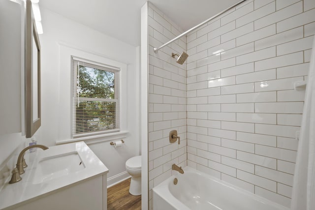 130 N Horton St, Jackson, MI 49202 - full bathroom with toilet, vanity, shower / bath combo with shower curtain, and wood finished floors