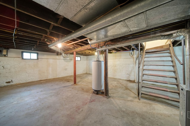 130 N Horton St, Jackson, MI 49202 - below grade area featuring water heater and stairway