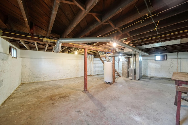 130 N Horton St, Jackson, MI 49202 - below grade area featuring heating unit, water heater, and stairway