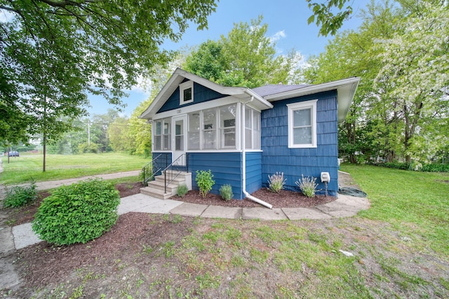 130 N Horton St, Jackson, MI 49202 - view of front of property with a front lawn and a sunroom