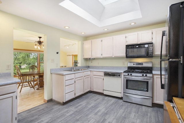 614 Marshall Rd, Coldwater, MI 49036 - kitchen featuring black appliances, a sink, dark wood-style floors, a skylight, and recessed lighting
