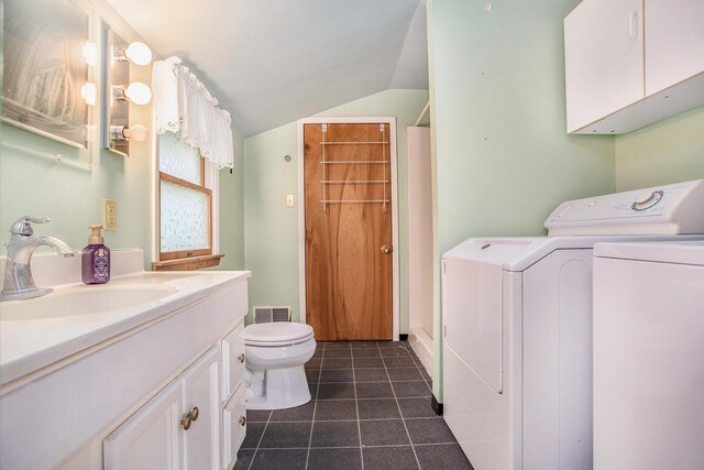 614 Marshall Rd, Coldwater, MI 49036 - bathroom featuring separate washer and dryer, lofted ceiling, vanity, toilet, and tile patterned flooring