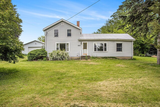 614 Marshall Rd, Coldwater, MI 49036 - back of property featuring entry steps, an outbuilding, a lawn, a chimney, and a detached garage