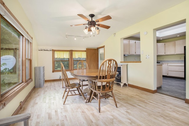 614 Marshall Rd, Coldwater, MI 49036 - dining space featuring light wood-style floors, baseboards, vaulted ceiling, a ceiling fan, and rail lighting