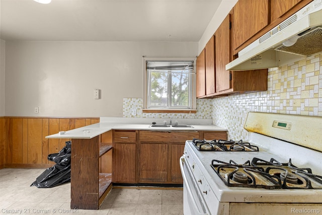 25960 Yale St, Inkster, MI 48141 - kitchen featuring white gas range oven, under cabinet range hood, a sink, light countertops, and brown cabinets