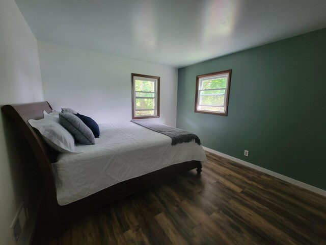 1328 S Montgomery St, Hastings, MI 49058 - bedroom featuring dark wood-style flooring and baseboards