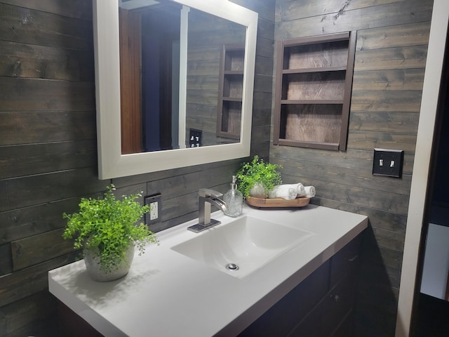 1328 S Montgomery St, Hastings, MI 49058 - bathroom featuring wood walls and vanity
