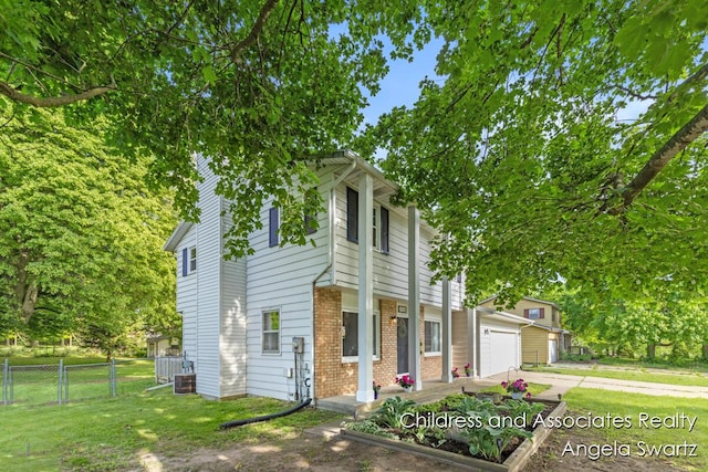 1328 S Montgomery St, Hastings, MI 49058 - view of front facade with brick siding, driveway, and central AC