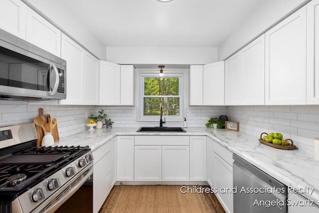1328 S Montgomery St, Hastings, MI 49058 - kitchen featuring appliances with stainless steel finishes, a sink, and backsplash