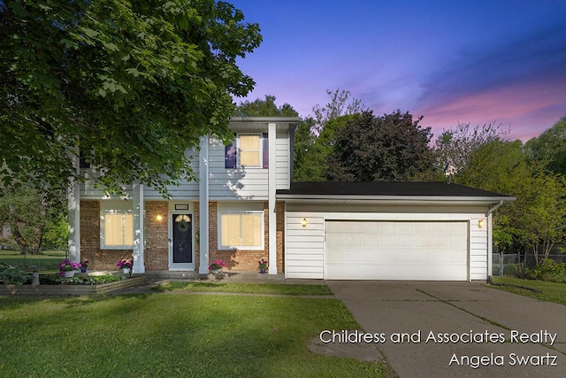 1328 S Montgomery St, Hastings, MI 49058 - view of front facade featuring driveway, a garage, and brick siding