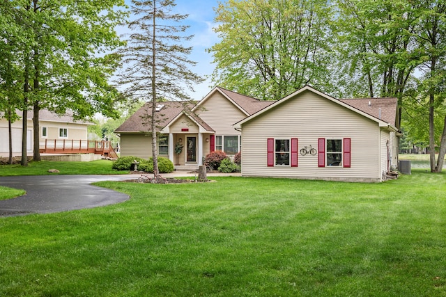 9228 Main St, Canadian Lakes, MI 49346 - view of front of home with a shingled roof, a front lawn, and cooling unit