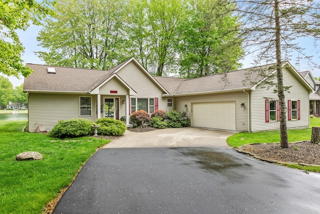 9228 Main St, Canadian Lakes, MI 49346 - ranch-style home with a garage, asphalt driveway, a front yard, and a shingled roof
