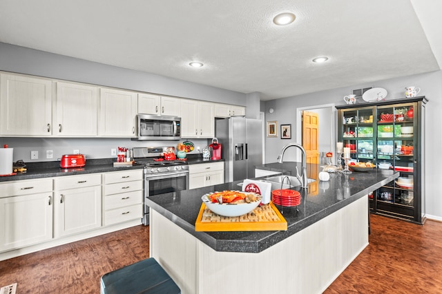 9228 Main St, Canadian Lakes, MI 49346 - kitchen with appliances with stainless steel finishes, white cabinets, a sink, recessed lighting, and dark countertops