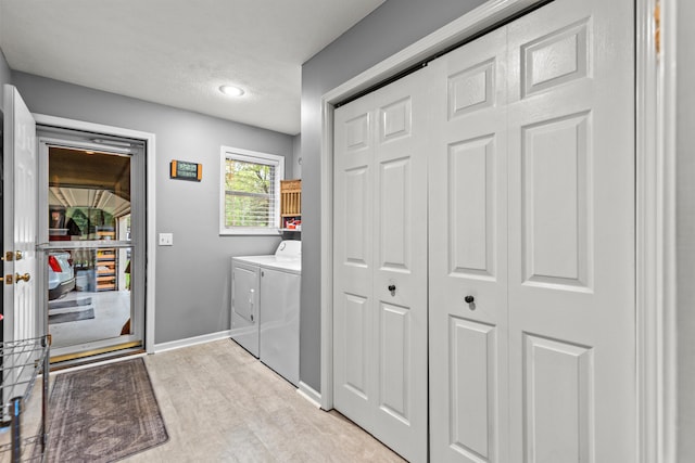 9228 Main St, Canadian Lakes, MI 49346 - washroom featuring separate washer and dryer, baseboards, and a textured ceiling