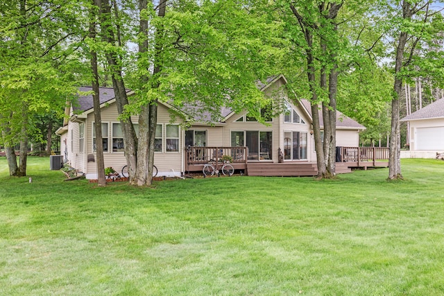9228 Main St, Canadian Lakes, MI 49346 - rear view of property with central AC unit, a wooden deck, a lawn, and roof with shingles