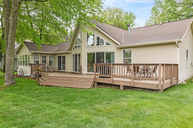 9228 Main St, Canadian Lakes, MI 49346 - rear view of house with roof with shingles, a lawn, and a wooden deck