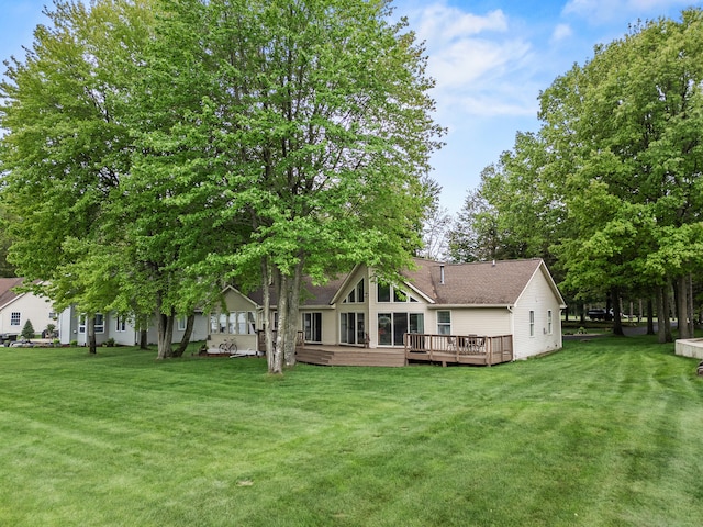 9228 Main St, Canadian Lakes, MI 49346 - rear view of house featuring a yard, a wooden deck, and roof with shingles